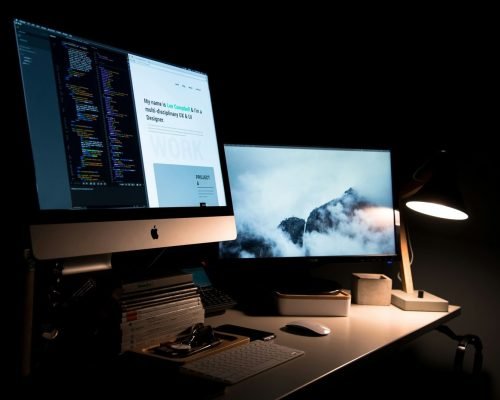 silver iMac turned on inside room